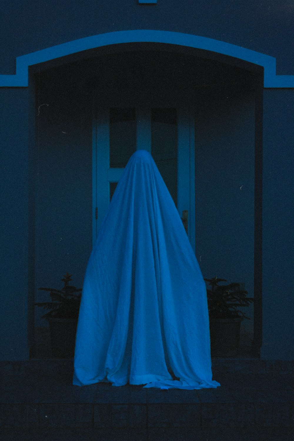 blue textile on dark room