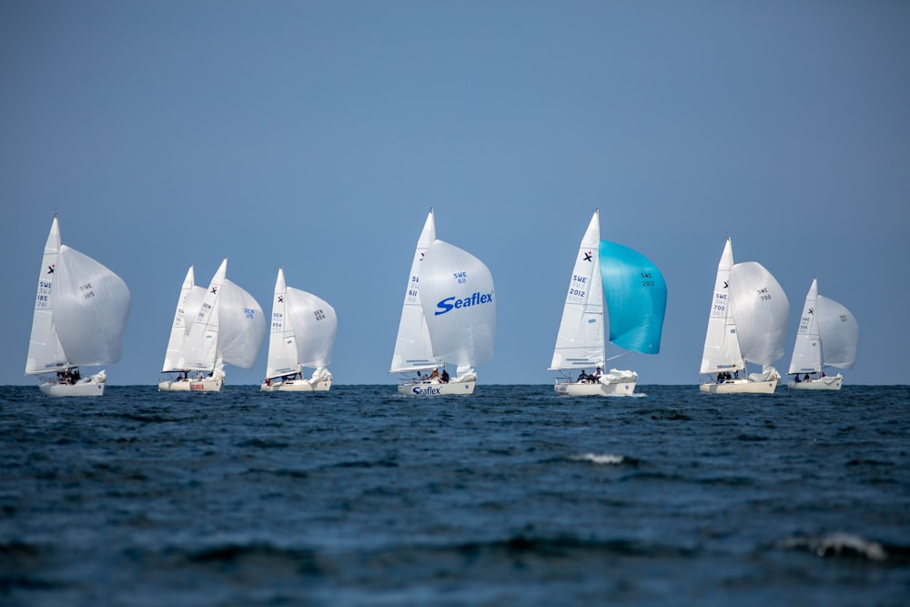 white and red sail boats on sea during daytime