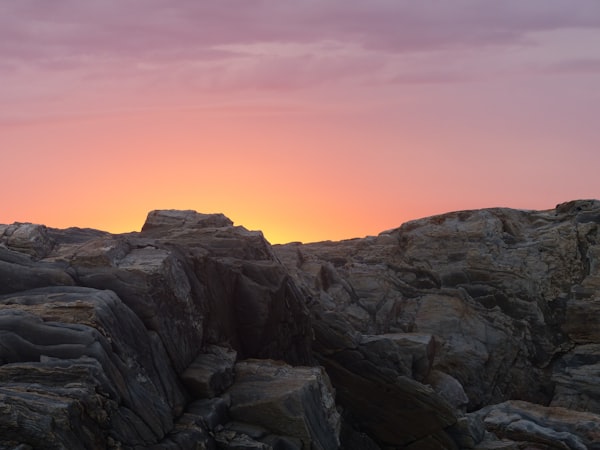 A sunrise over a rocky mountain.