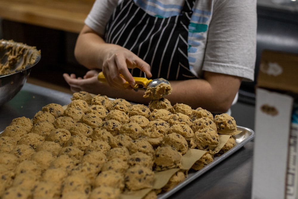 person holding tray with cookies