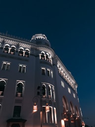 low angle photography of gray concrete building under blue sky during daytime