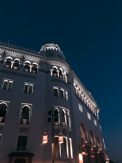 low angle photography of gray concrete building under blue sky during daytime