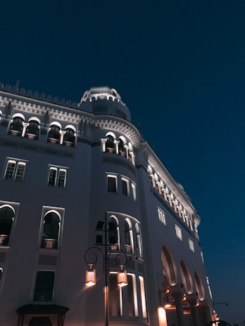 low angle photography of gray concrete building under blue sky during daytime
