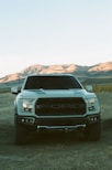 white ford car on dirt road during daytime