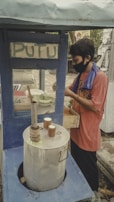 Street food vendor preparing gudeg, a famous Yogyakarta dish, with steam rising from the pot.