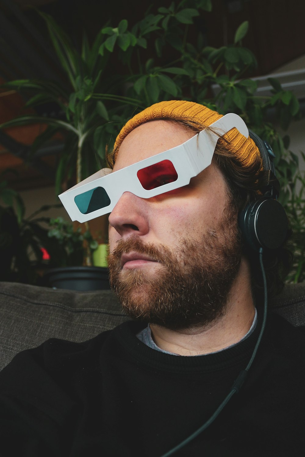 man in black crew neck shirt wearing white sunglasses and headphones