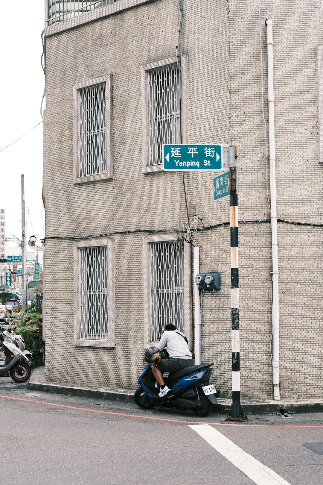 man in blue jacket riding on black motorcycle