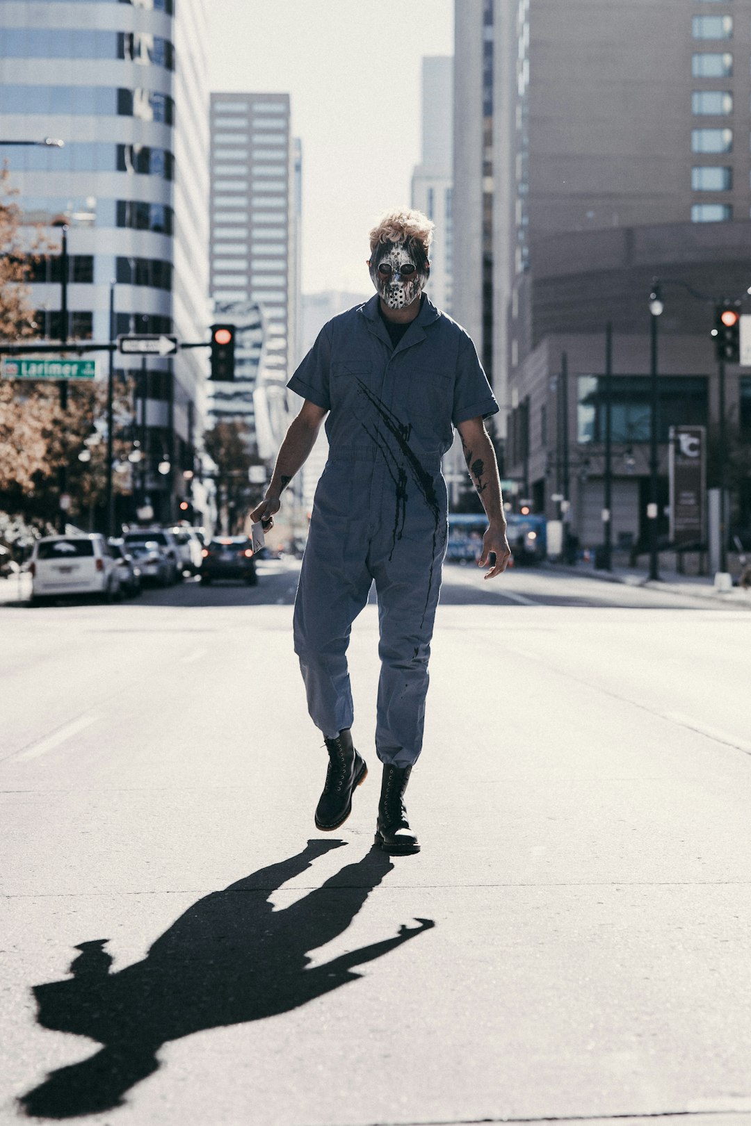 man in black t-shirt and gray pants walking on street during daytime