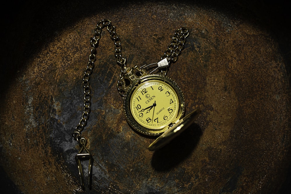 gold pocket watch at 10 00