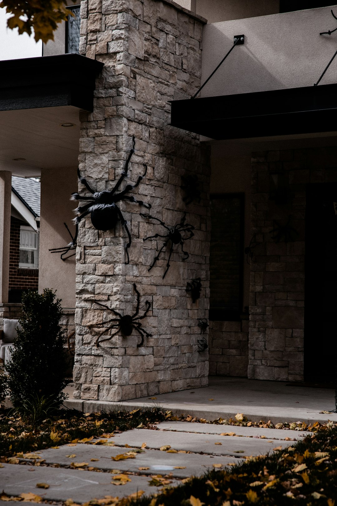 black metal wall decor on brown brick wall