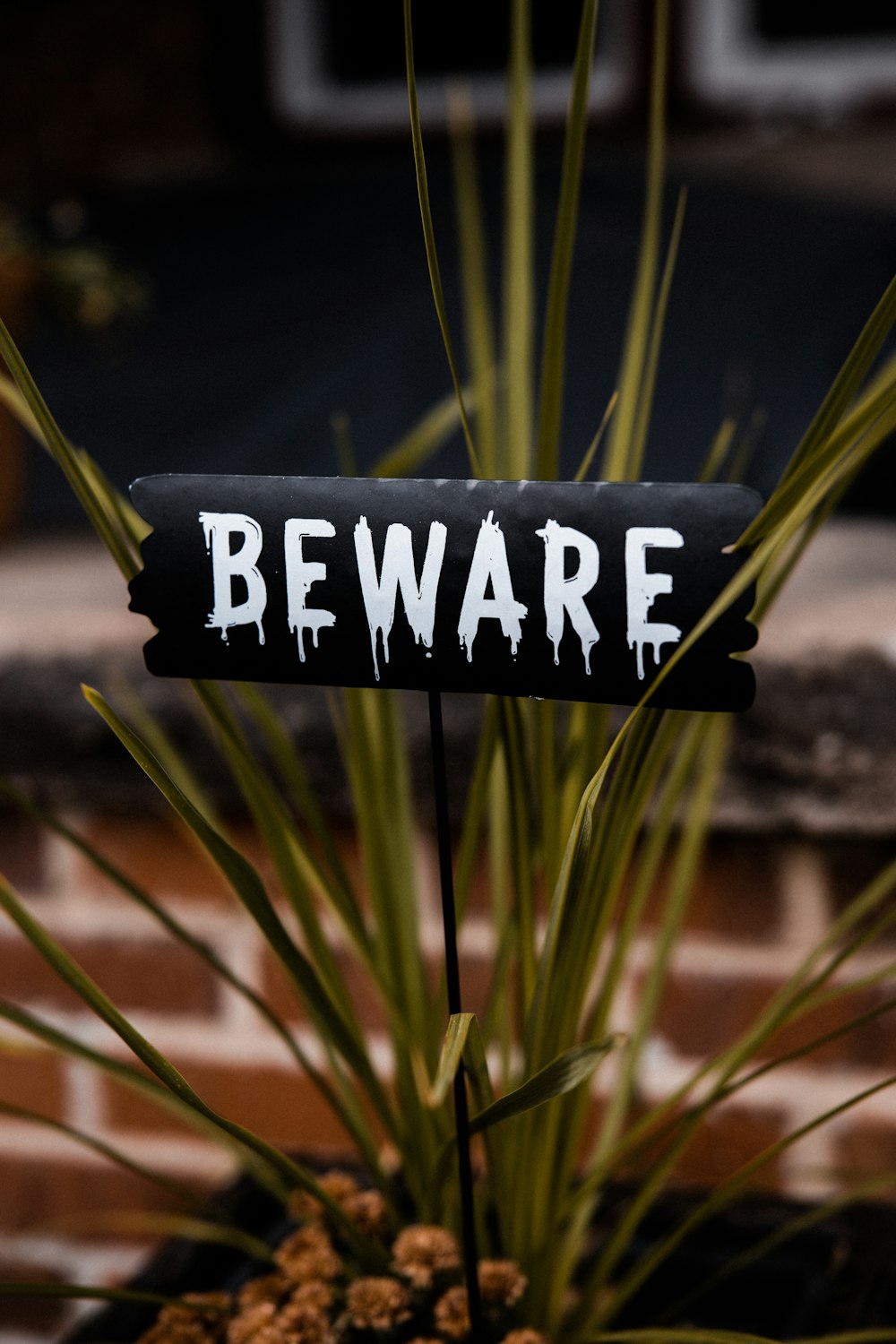 a black and white sign that says beware