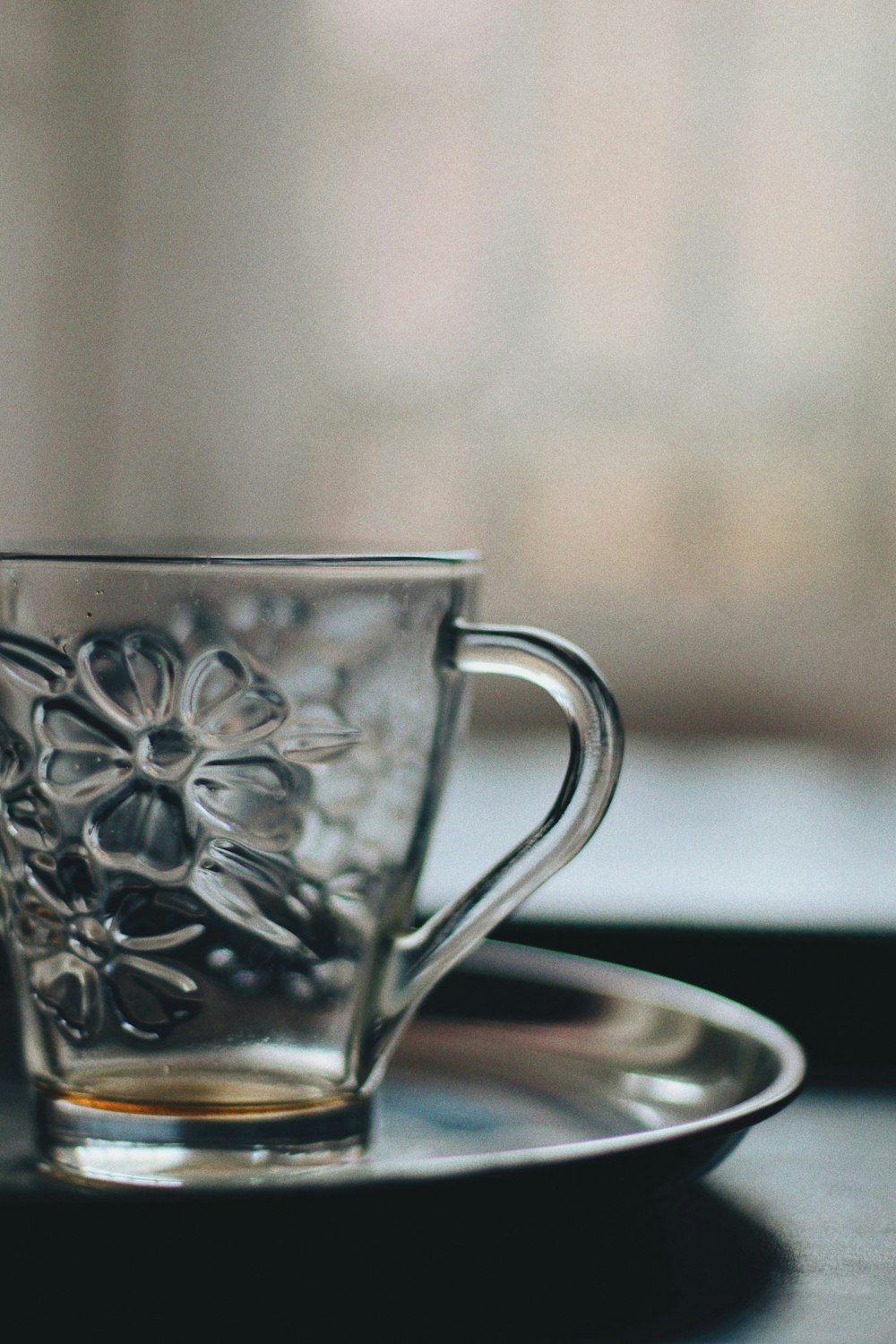 silver floral cup on saucer