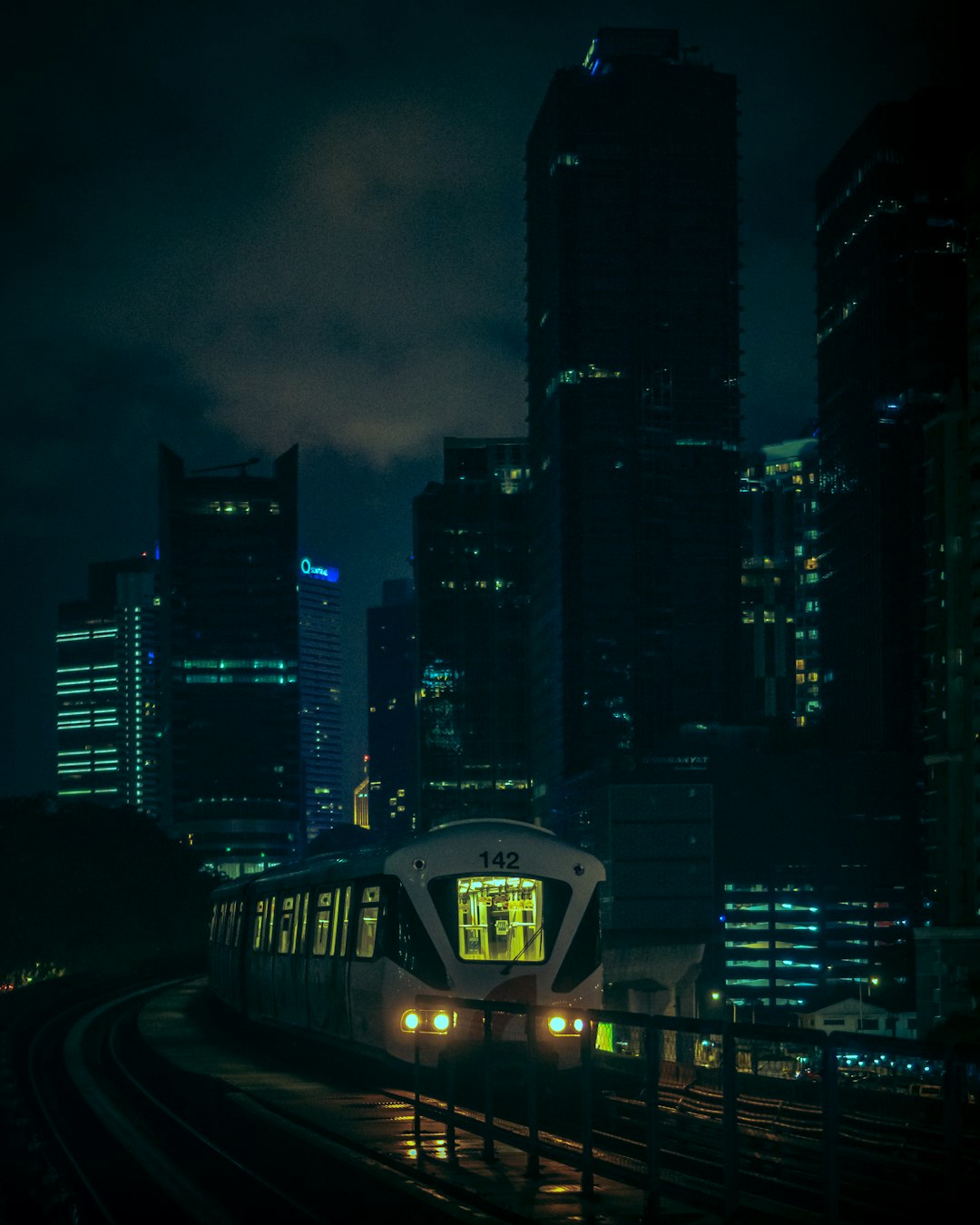 white train on rail road during night time