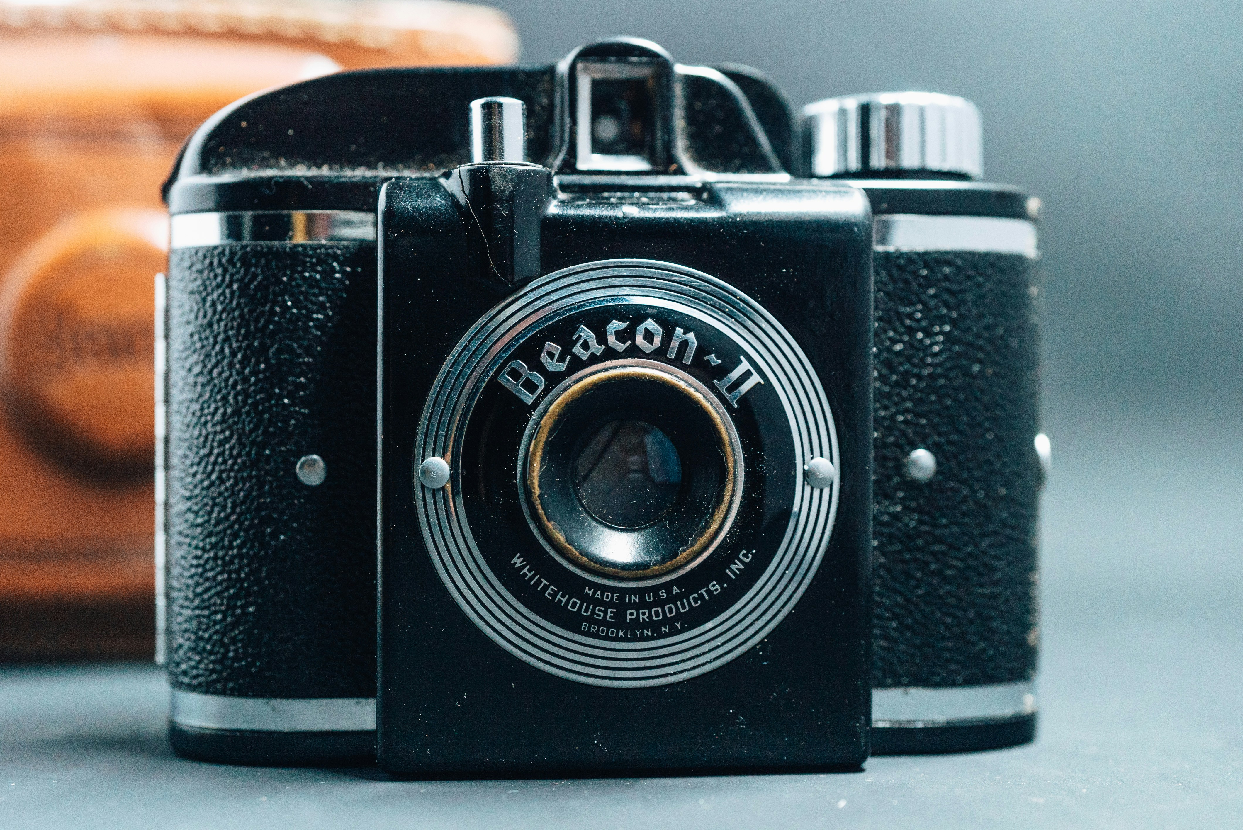 black and silver camera on brown wooden table