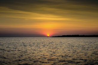 body of water during sunset