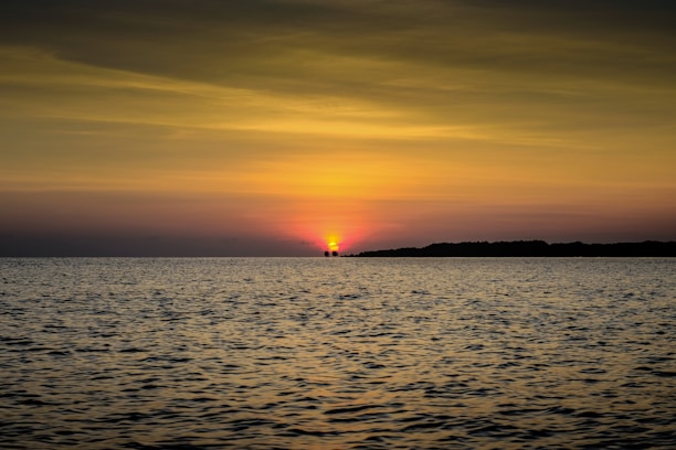 body of water during sunset