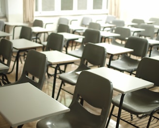 white table with black chairs in a school cleaned professionally by commercial cleaners