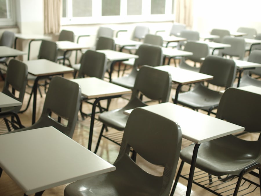 empty modern classroom with rows of plastic chairs and desks