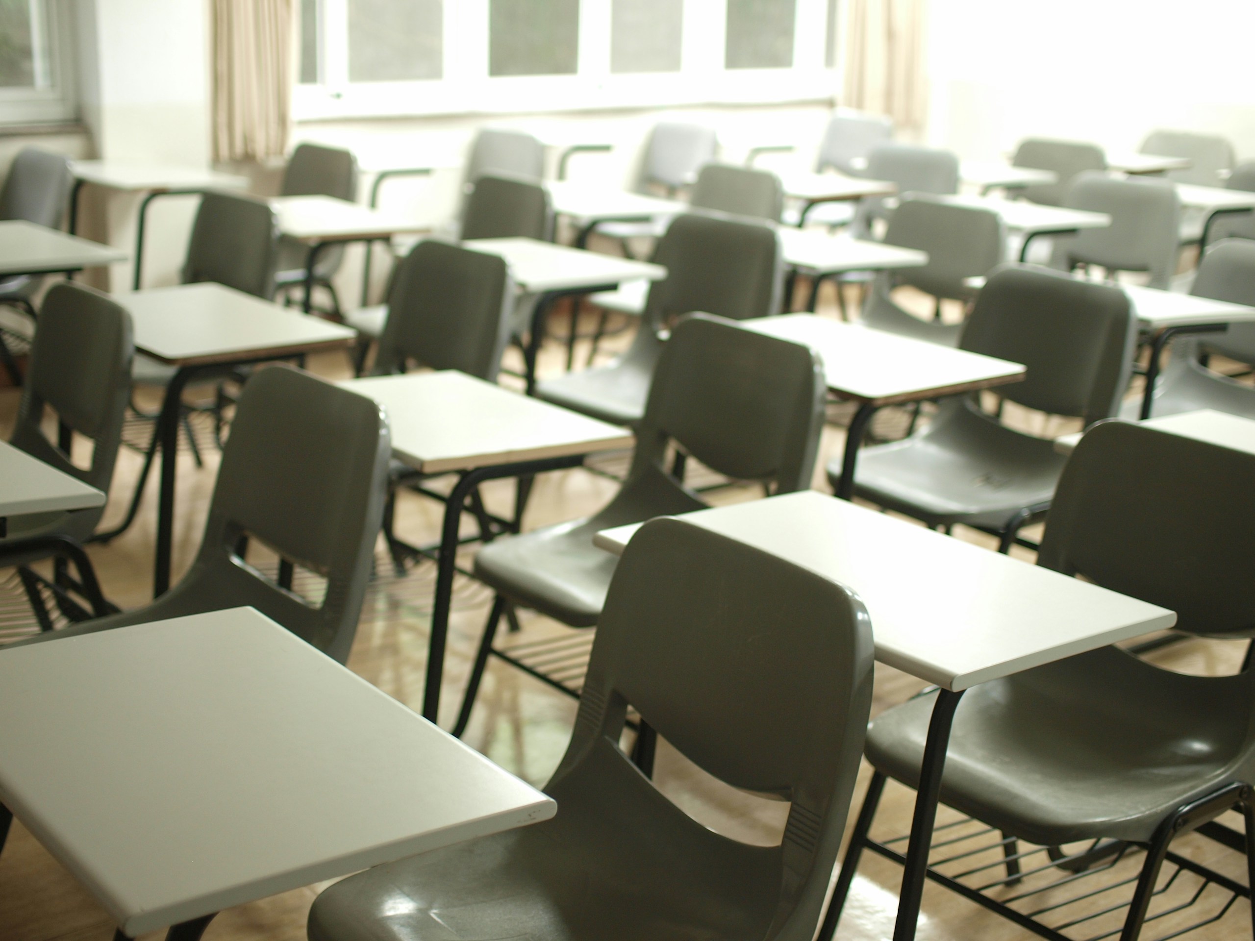  a photo of an empty classroom with desks and chairs