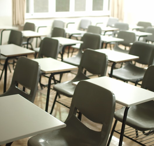 white table with black chairs by MChe Lee (https://unsplash.com/@mclee)