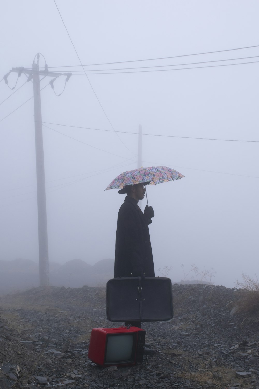 person standing under umbrella during daytime