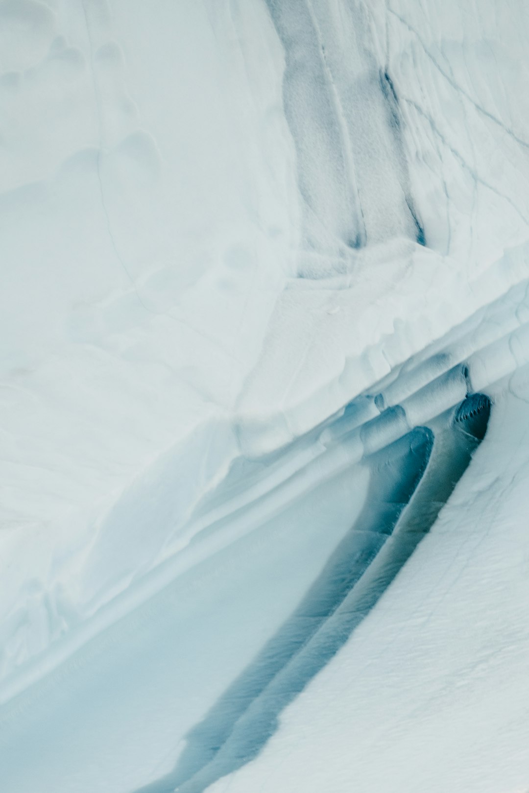 person in black pants walking on white snow