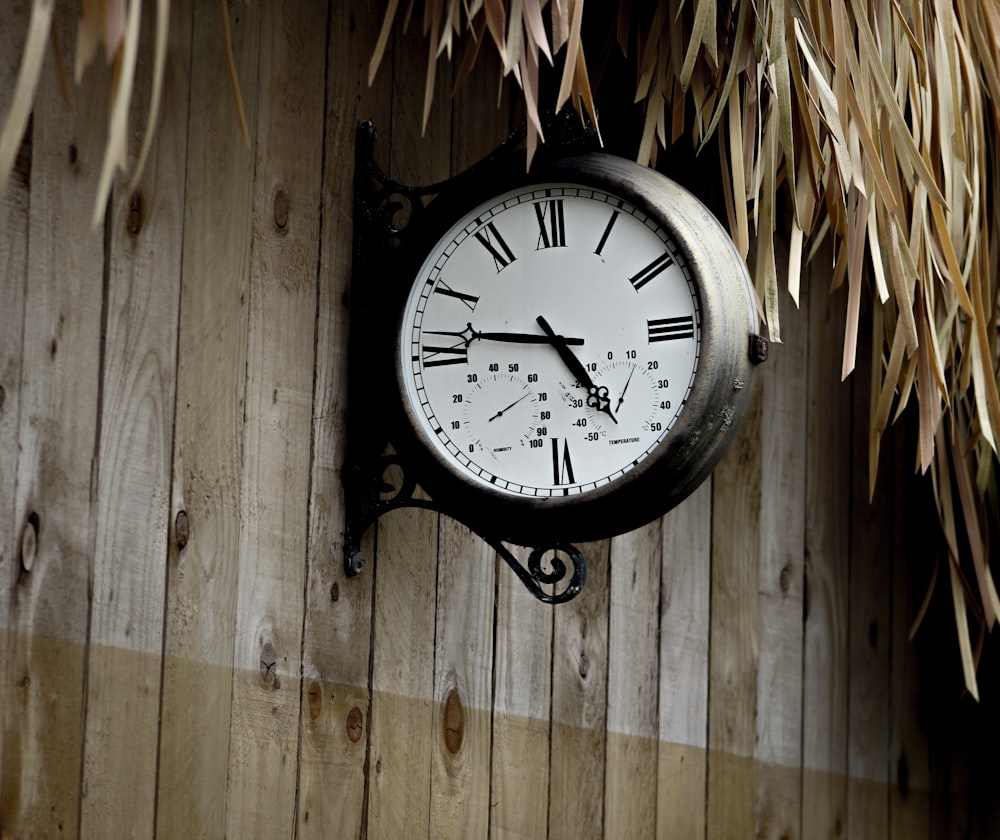 black and white round analog wall clock at 10 00