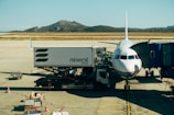 white and blue airplane on airport during daytime