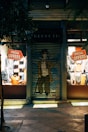 man in black and white checkered dress shirt standing in front of store