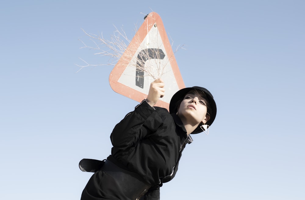 woman in black jacket holding orange and white basketball hoop