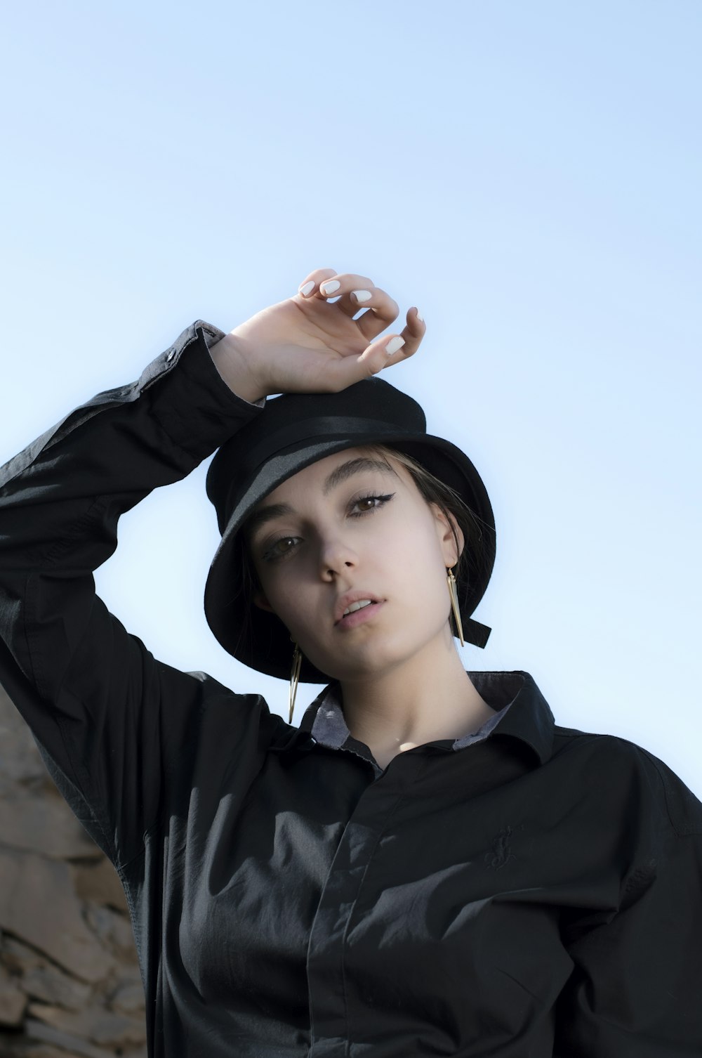 woman in black hoodie wearing black cap