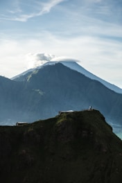person standing on top of mountain during daytime