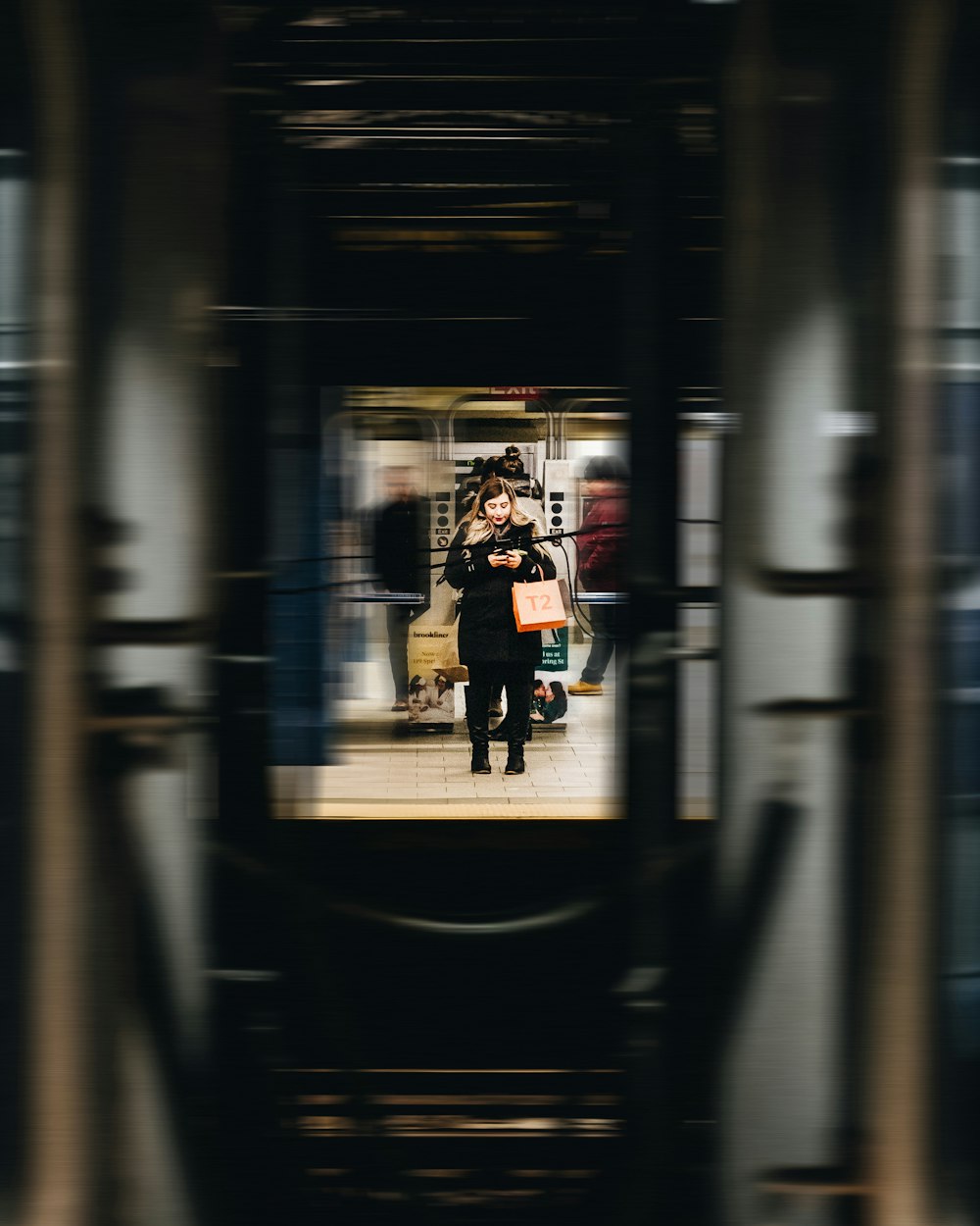 woman in black jacket and black pants standing on hallway