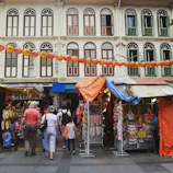 A family exploring vibrant street markets in Singapore, capturing joyful moments.