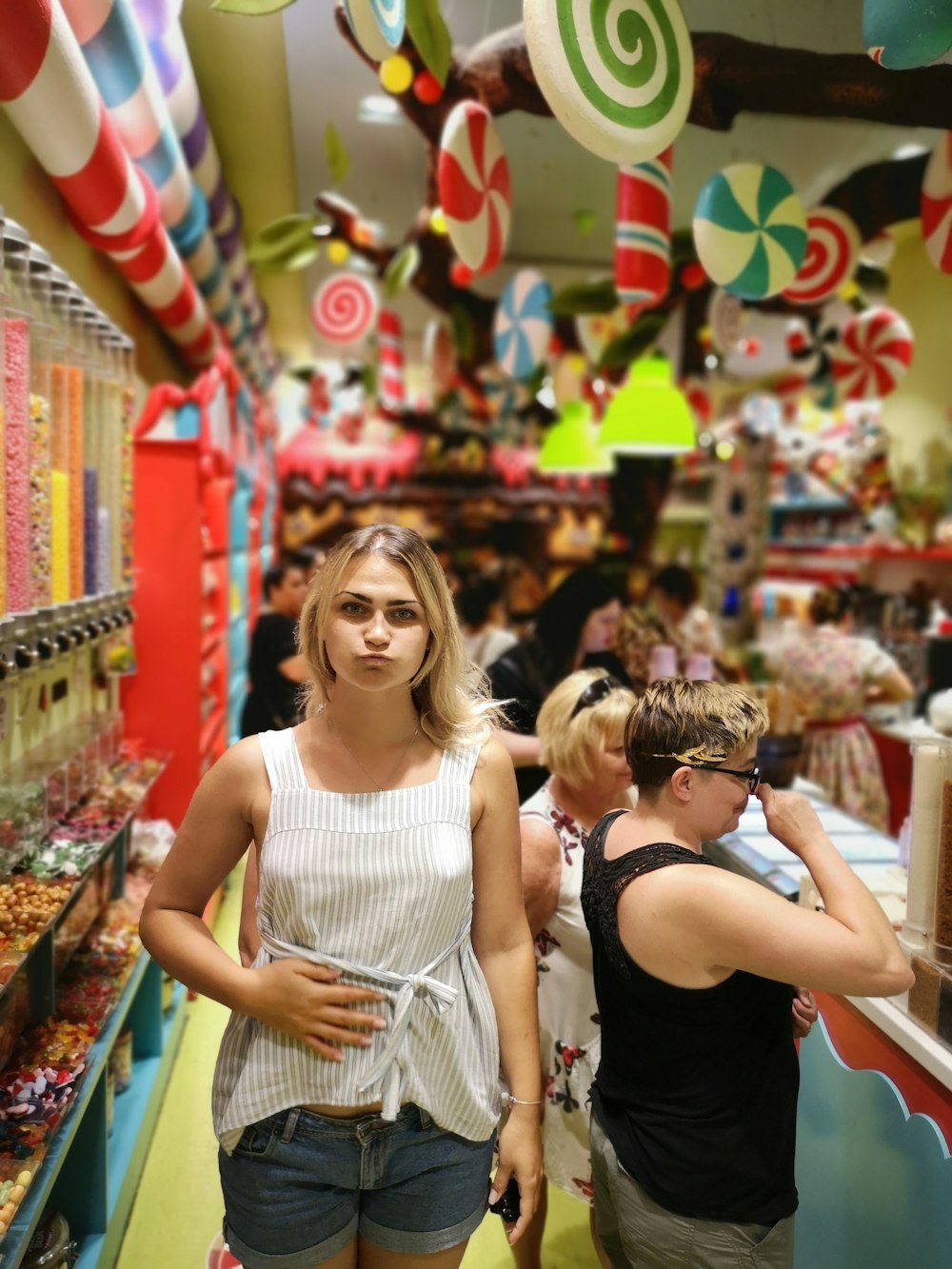 woman in white tank top standing beside woman in black tank top