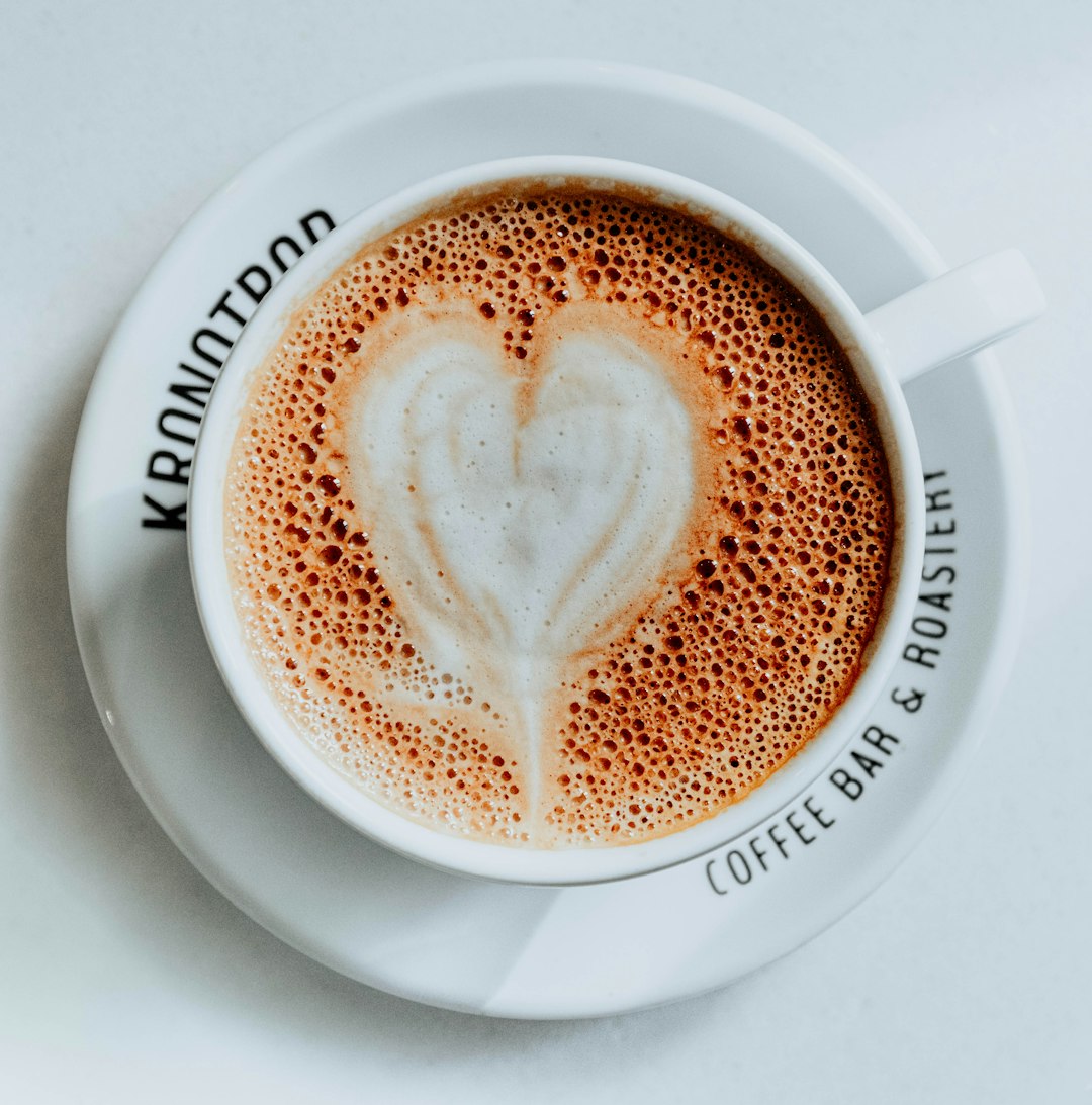 white ceramic mug with brown liquid