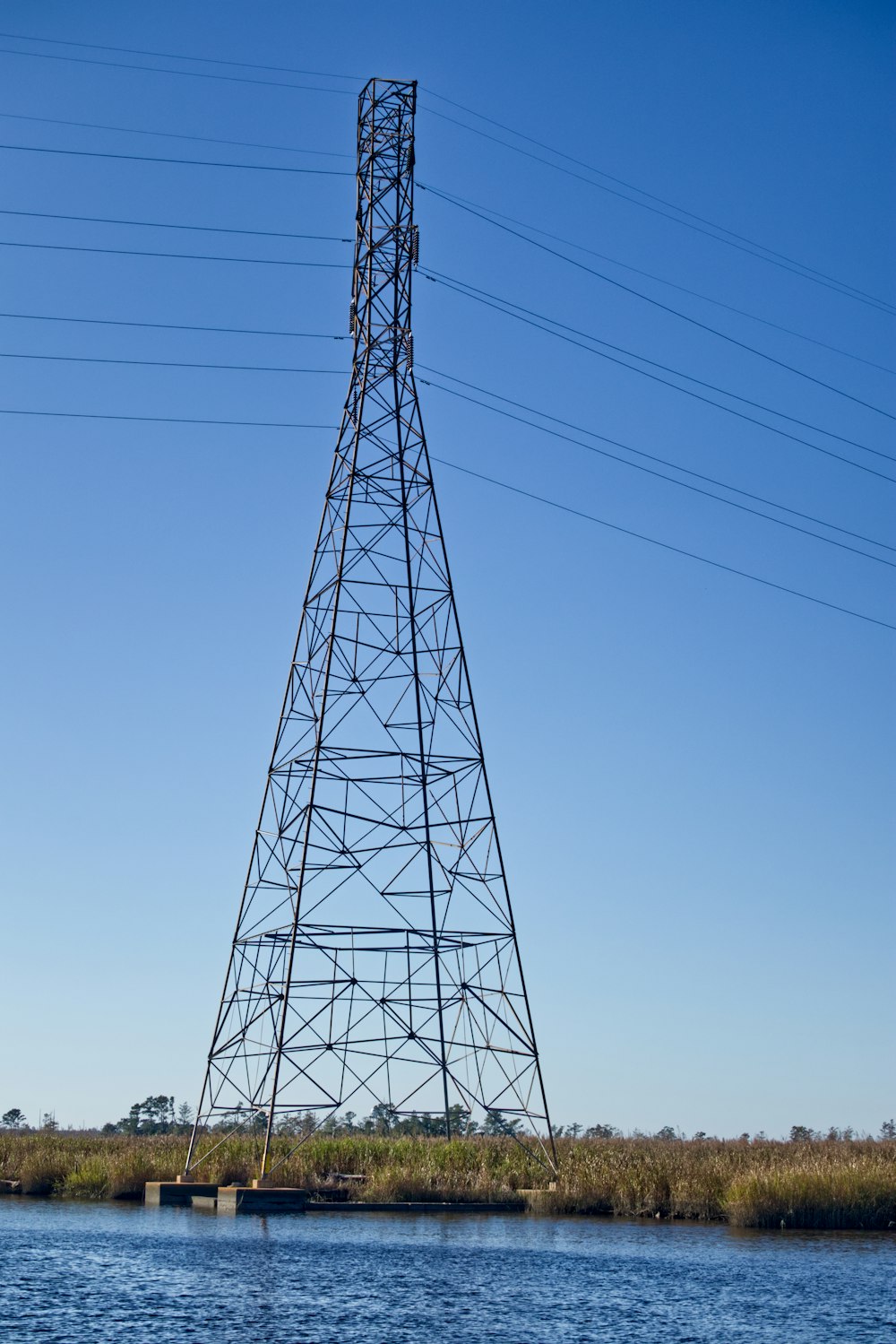 black electric tower under blue sky during daytime