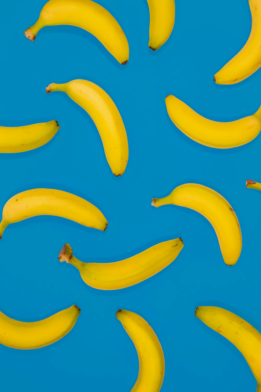 frutti di banana gialli su superficie blu