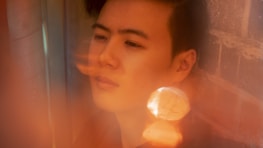 An artistic photo of a cosplay scene with soft focus and warm tones.