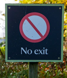 A clear signpost with multiple arrows pointing to 'No Entry' zones, symbolizing service exclusions.