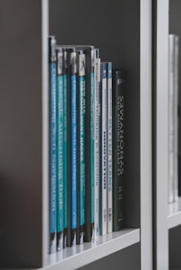 books on white wooden shelf