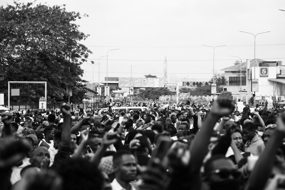 grayscale photo of people in the street