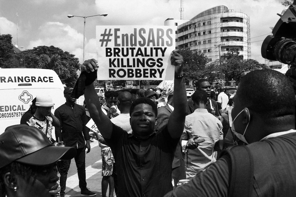 a black and white photo of people protesting