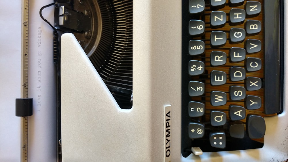 white and black typewriter on white table