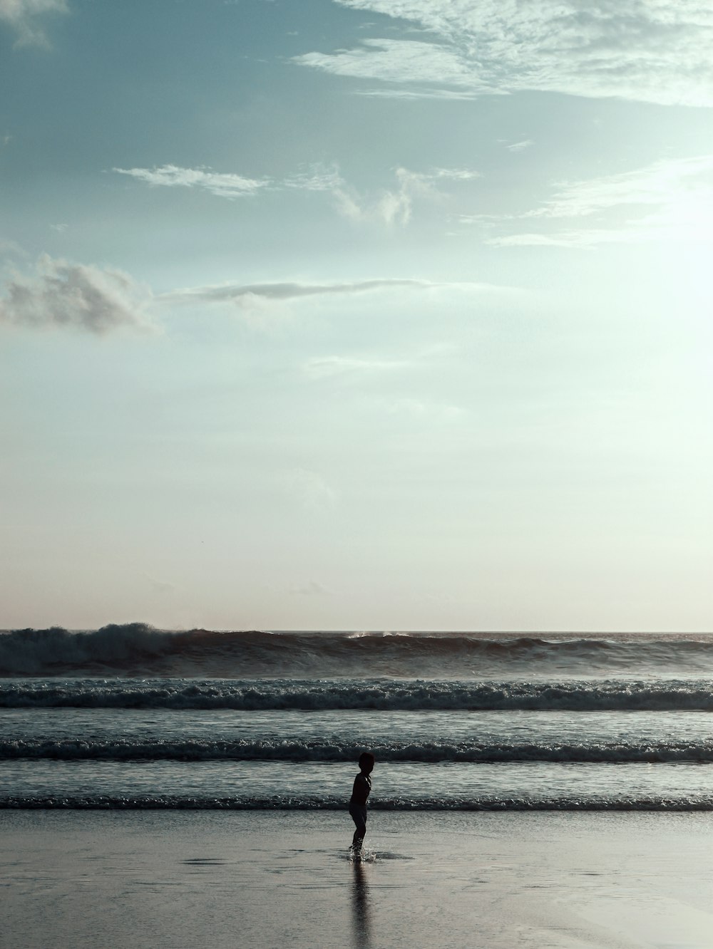 person walking on beach during daytime