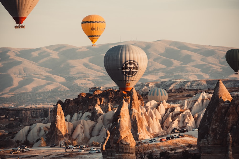 hot air balloon over the brown mountains