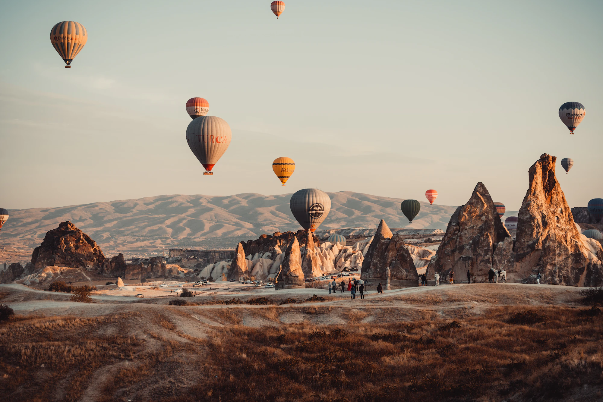 Chimneys of Cappadocia with hot air balloons in the background