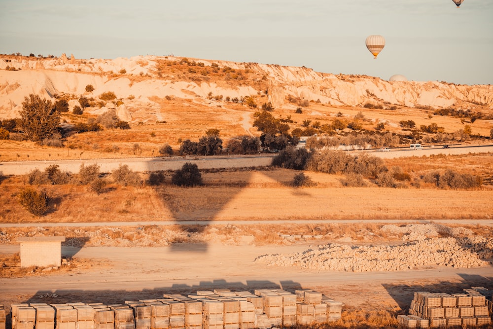 hot air balloon flying over the field during daytime