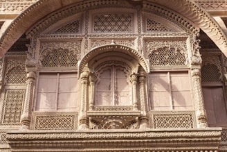 Close-up of detailed stone carvings on the hotel facade, showcasing Rajasthan’s rich architectural heritage.