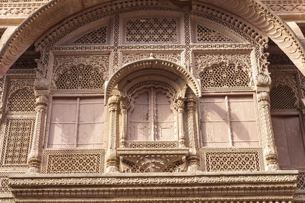 Close-up of detailed stone carvings on the hotel facade, showcasing Rajasthan’s rich architectural heritage.